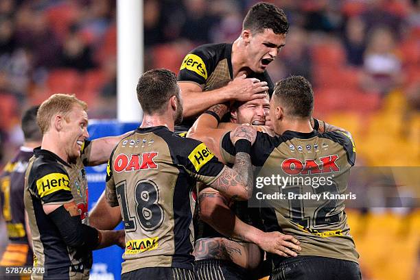 Trent Merrin of the Panthers is congratulated by team mates after scoring a try during the round 20 NRL match between the Brisbane Broncos and the...