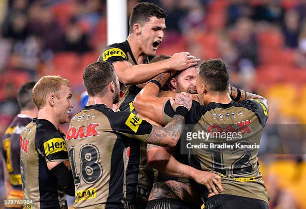 Trent Merrin of the Panthers is congratulated by team mates after scoring a try during the round 20 NRL match between the Brisbane Broncos and the...