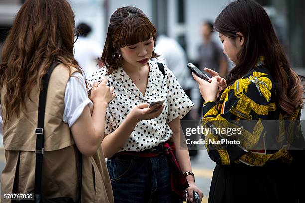 Pokemon players plays in the street of Shibuya district as &quot;Pokemon Go&quot; finally launches it's first day in Japan on Friday, July 22, 2016.