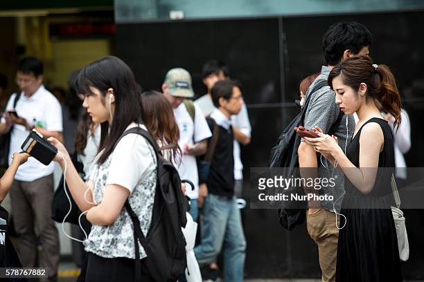 Pokemon players plays in the street of Shibuya district as &quot;Pokemon Go&quot; finally launches it's first day in Japan on Friday, July 22, 2016.