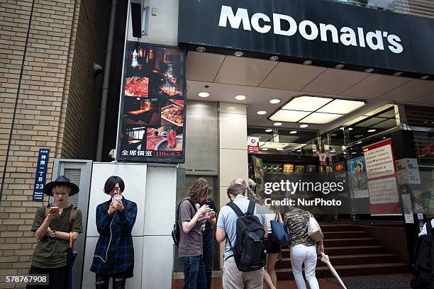 Pokemon players plays outside of McDonald's in Shibuya district as &quot;Pokemon Go&quot; finally launches it's first day in Japan on Friday, July...