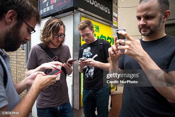 Foreign Pokemon players plays outside of McDonald's in Shibuya district as &quot;Pokemon Go&quot; finally launches it's first day in Japan on Friday,...