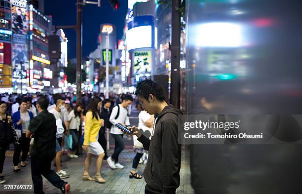 Ayato plays the Pokemon Go game on his smartphone on July 22, 2016 in Tokyo, Japan. The Japanese version of the game app Pokemon Go was released on...