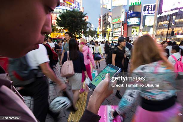 Ayato plays the Pokemon Go game on his smartphone on July 22, 2016 in Tokyo, Japan. The Japanese version of the game app Pokemon Go was released on...