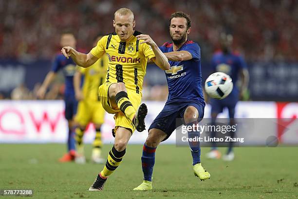 Juan Mata of Manchester United competes for the ball with Sebastian Rode of Borussia Dortmund during the International Champions Cup match between...