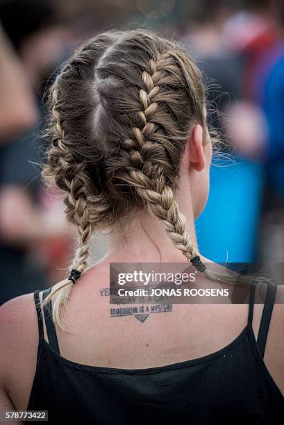 Woman with a Tomorrowland tattoo is seen during the first day of the 12th edition of the Tomorrowland electronic music festival, on July 22, 2016 in...