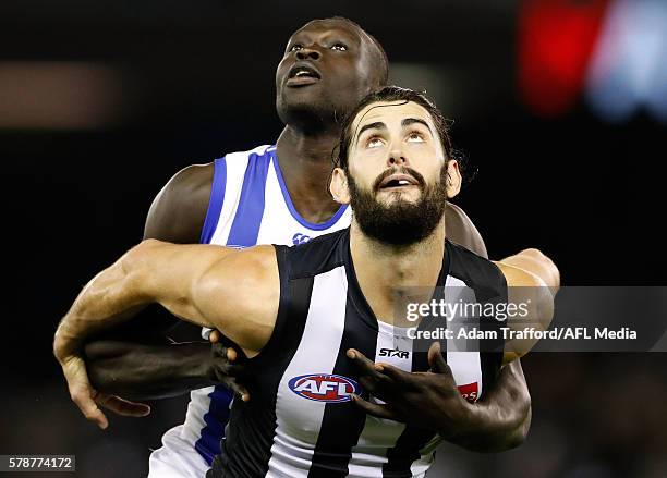 Brodie Grundy of the Magpies and Majak Daw of the Kangaroos compete in a ruck contest during the 2016 AFL Round 18 match between the Collingwood...