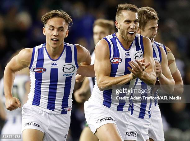 Jamie Macmillan of the Kangaroos celebrates a goal with teammates during the 2016 AFL Round 18 match between the Collingwood Magpies and the North...