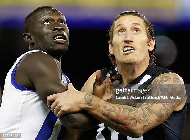 Majak Daw of the Kangaroos and Jesse White of the Magpies compete in a ruck contest during the 2016 AFL Round 18 match between the Collingwood...