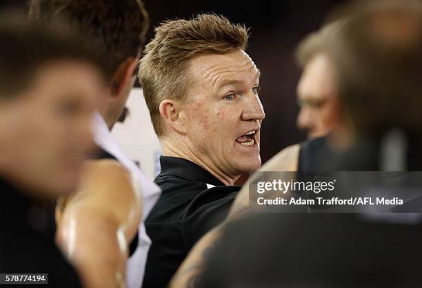 Nathan Buckley, Senior Coach of the Magpies addresses his players during the 2016 AFL Round 18 match between the Collingwood Magpies and the North...