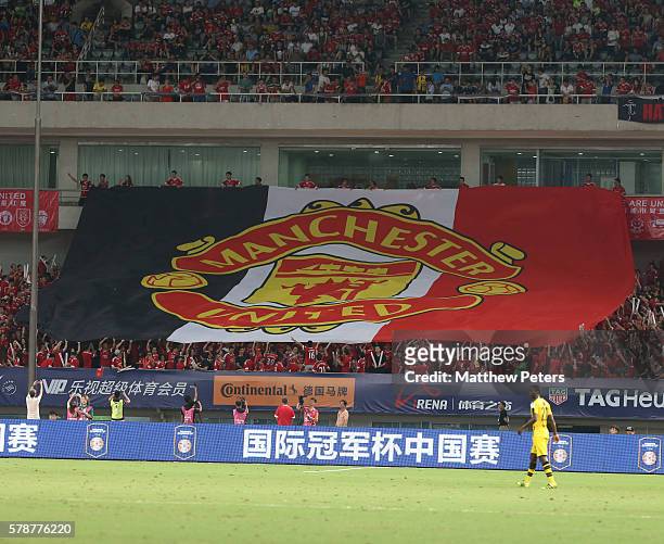 Manchester United fans display a large flag during the pre-season friendly match between Manchester United and Borussia Dortmund at Shanghai Stadium...