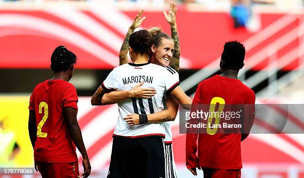 Dzsenifer Maroszan of Germany celebrates with Simone Laudehr of Germany after scoring her teams second goal during the women's international friendly...