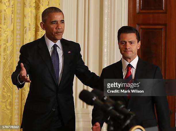 President Barack Obama and Mexican President Enrique Pena Nieto arrive to speak to the media during a news conference in the East Room at the White...
