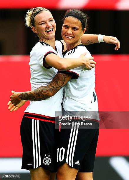 Alexandra Popp of Germany celebrates with Dzsenifer Maroszan of Germany after scoring her teams fifth goal during the women's international friendly...