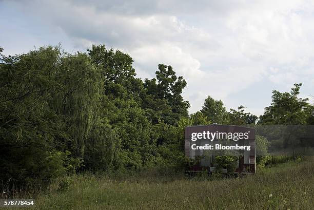 Overgrown grass and weeds surround a trailer home in Pomeroy, Ohio, U.S., on Monday, July 18, 2016. Donald Trumps message, repeated at the Republican...