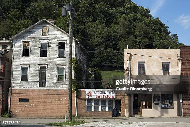 An abandoned home stands next to a thrift store in Pomeroy, Ohio, U.S., on Monday, July 18, 2016. Donald Trumps message, repeated at the Republican...