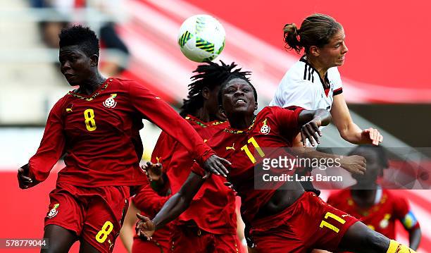 Priscilla Okyere of Ghana and Cynthia Abobea of Ghana go up for a header with Annike Krahn of Germany during the women's international friendly match...