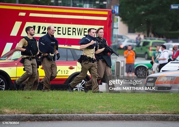 Police walks near a shopping mall amid a shooting on July 22, 2016 in Munich. Several people were killed on Friday in a shooting rampage by a lone...