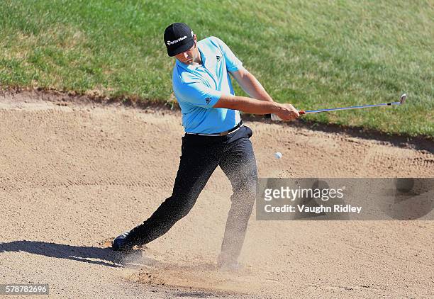 Jon Rahm of Spain hits from a green side sand trap to 14th green during the second round of the RBC Canadian Open at Glen Abbey Golf Club on July 22,...