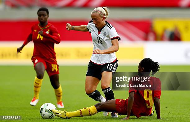 Mandy Islacker is challenged by Rita Darko of Ghana during the women's international friendly match between Germnay and Ghana at Benteler Arena on...