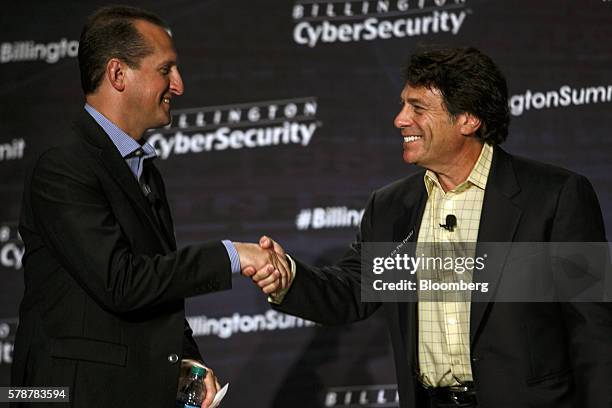 Jeffrey Massimilla, chief product cybersecurity officer for General Motors Co., shakes hands with Steven Center, vice president of the Environmental...