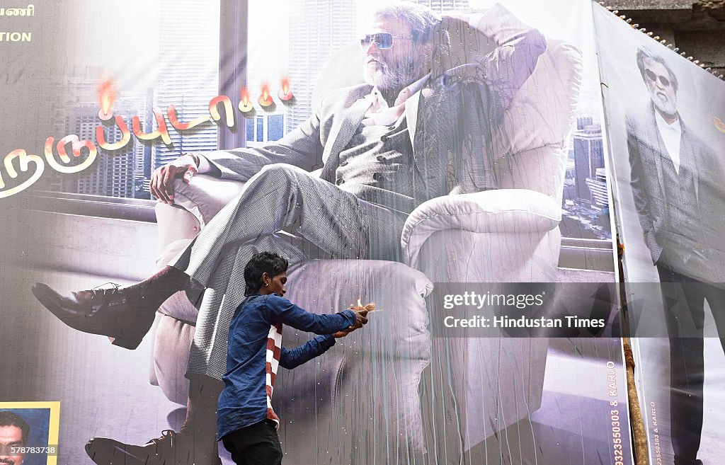 Sitting Rajnikanth A Rajinikanth fan performs aarti in front of Rajnikanth movie... News ...