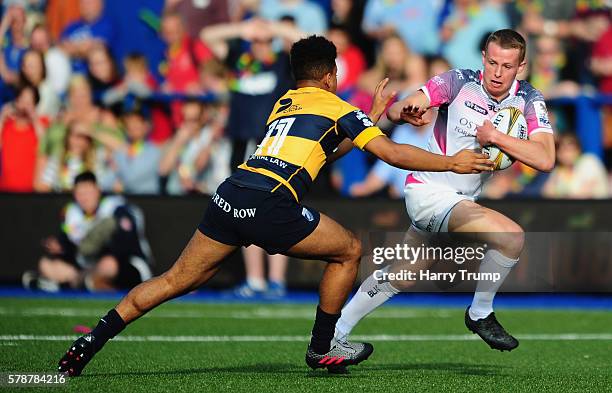 Phil Jones of Ospreys is tackled by Ben Thomas of Cardiff Blues during the Singha Premiership Rugby 7s Series match between Cardiff Blues and the...