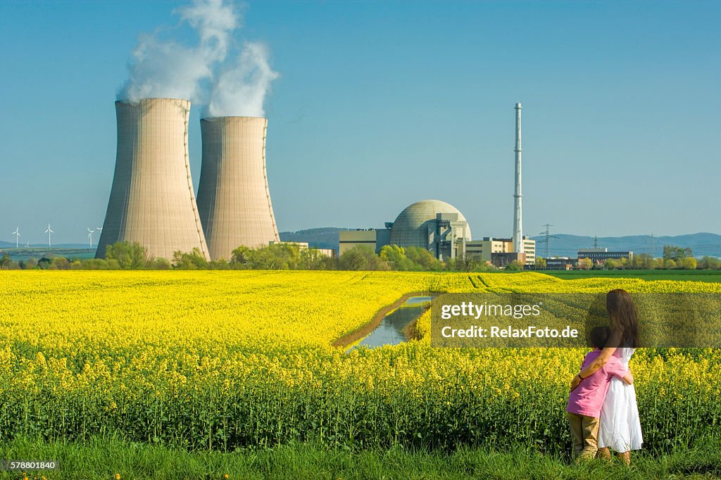 Mother embracing Son in Front of Nuclear power station
