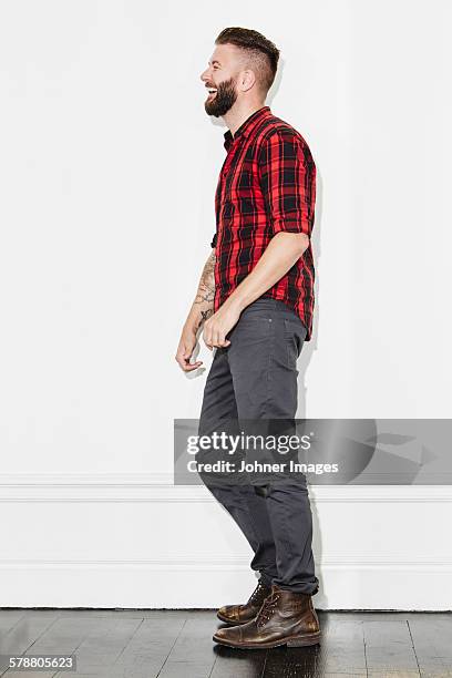 young man wearing checked shirt, studio shot - white boot stock pictures, royalty-free photos & images