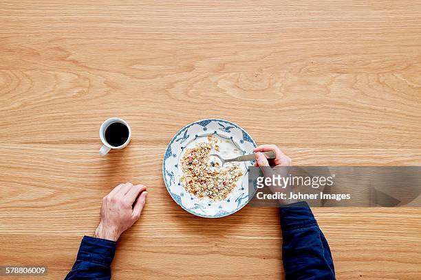 man eating cereals, directly above - johner images bildbanksfoton och bilder