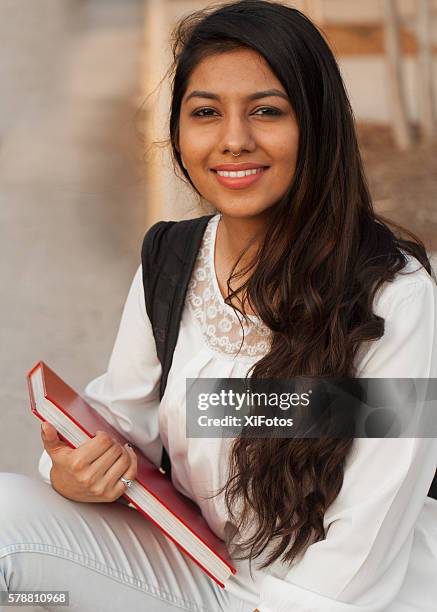 smiling female young college student of indian ethnicity - indian college girls stock pictures, royalty-free photos & images