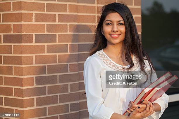 smiling female young college student of indian ethnicity - girls stock pictures, royalty-free photos & images