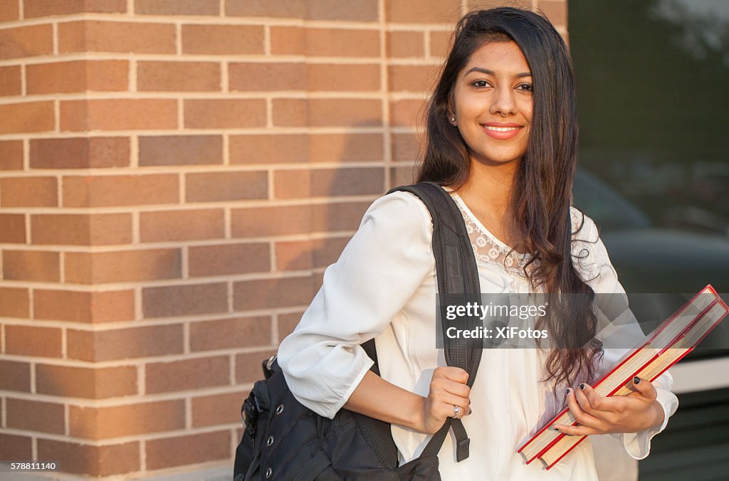 Smiling female young college student of Indian ethnicity