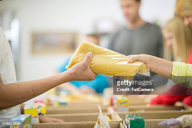 giving food for the homeless - food staple stock pictures, royalty-free photos & images
