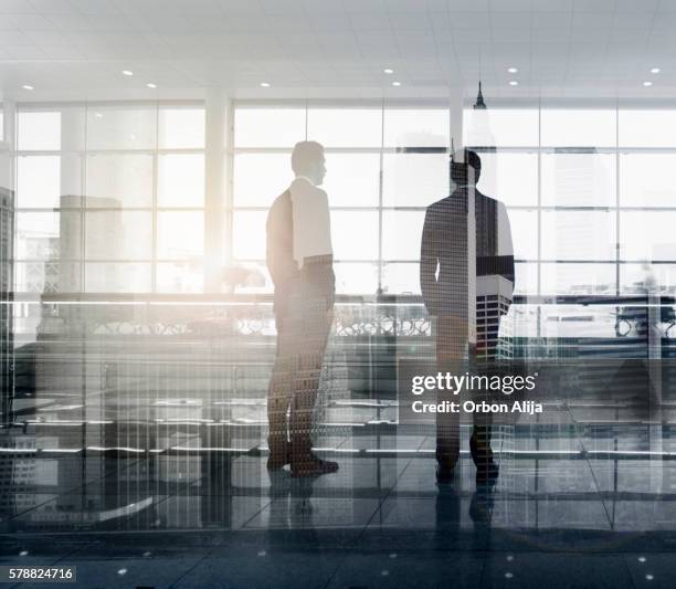 new york office - 2 businessmen in silhouette stock pictures, royalty-free photos & images