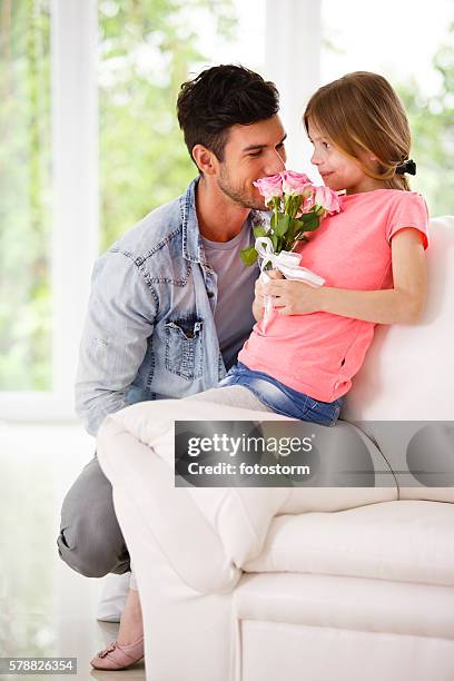 father and daughter with bouquet of pink roses - giving flowers stock pictures, royalty-free photos & images