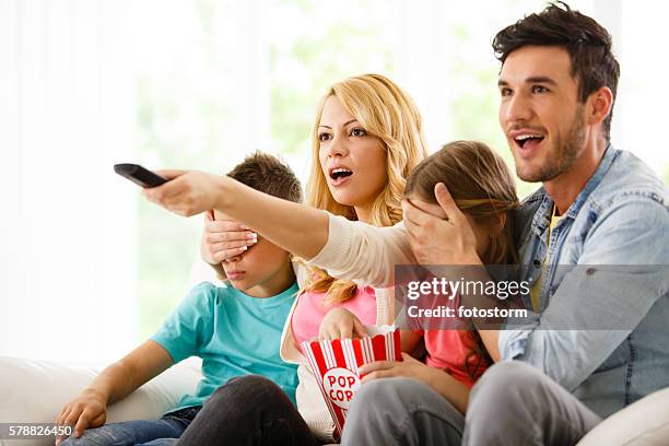 parents cover their children's eyes while watching tv - hands covering eyes stock pictures, royalty-free photos & images
