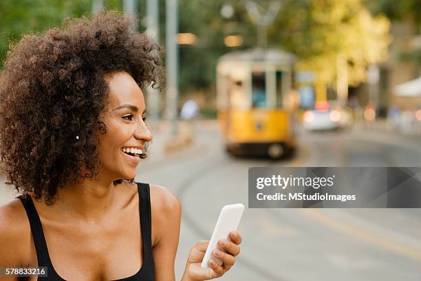 happy woman using mobile phone, - milan tram stock pictures, royalty-free photos & images