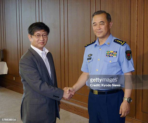 Japan - Kimito Nakae , Japan's administrative vice minister of defense, shakes hands with Gen. Ma Xiaotian, deputy chief of the general staff of...