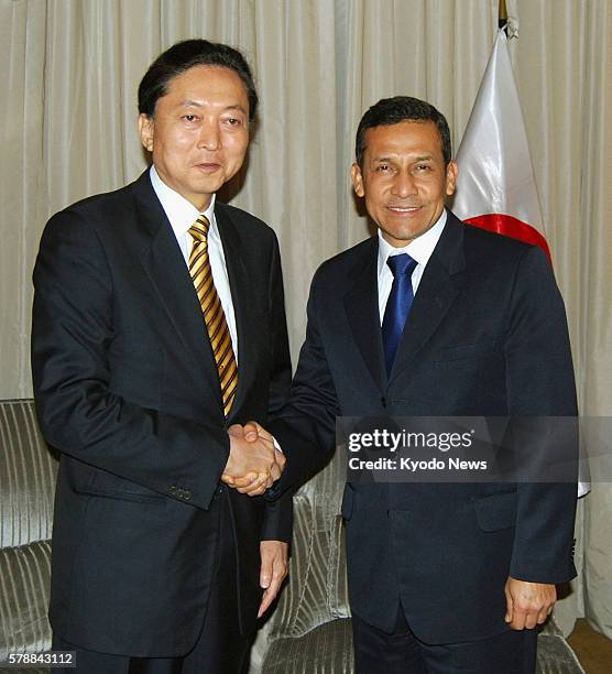 Peru - Former Japanese Prime Minister Yukio Hatoyama and incoming Peruvian President Ollanta Humala shake hands as they meet in Lima on July 27,...