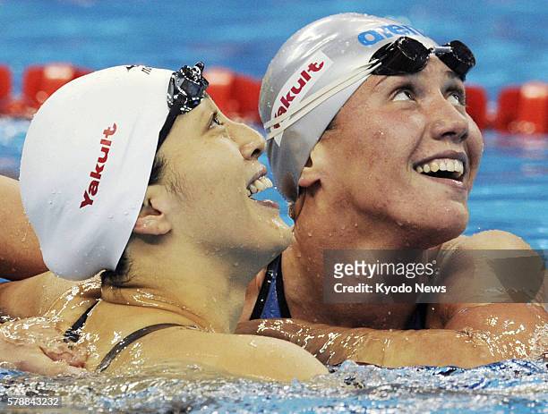 China - Anastasia Zueva of Russia and Aya Terakawa of Japan congratulate each other after the women's 50-meter backstroke final at the world swimming...