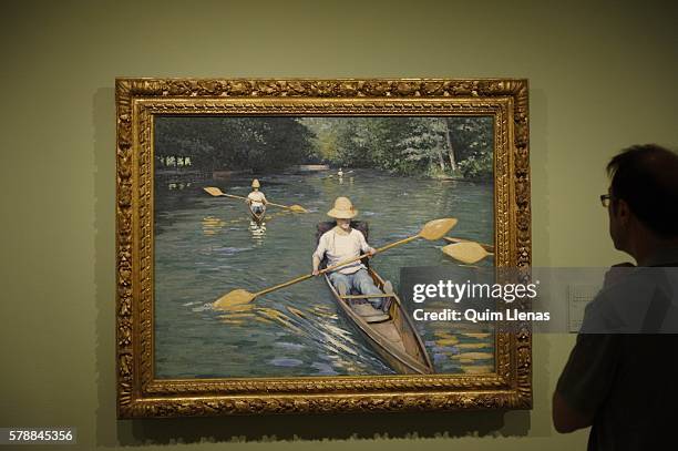 Visitor takes a look at Caillebotte's 'Skiffs on the River Yerres' during the press preview of the exhibition 'Caillebotte, pintor y jardinero' at...