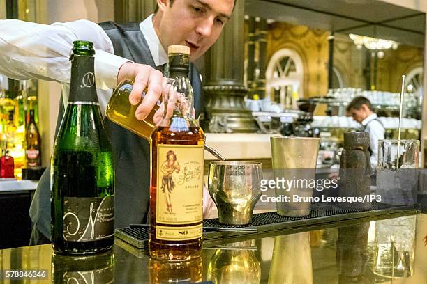Bartender mixes a cocktail in the bar of the Hilton Paris Opera, formerly known as the Grand Hotel Terminus, during a press visit organised by Paris...