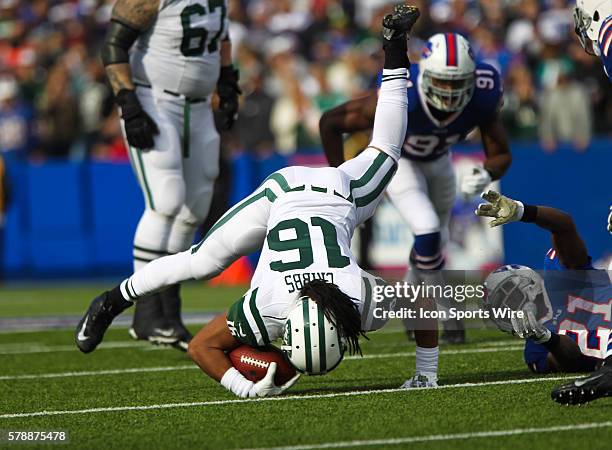 New York Jets wide receiver Josh Cribbs is sent flying after being tackled by Buffalo Bills cornerback Leodis McKelvin during a NFL game between the...