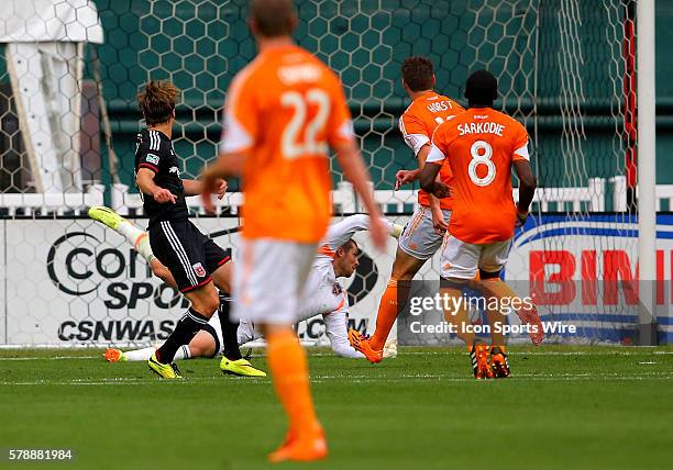 Chris Rolfe of D.C United watches his shot beat Tally Hall of the Houston Dynamo for the first goal during a MLS match at RFK Stadium, in Washington...