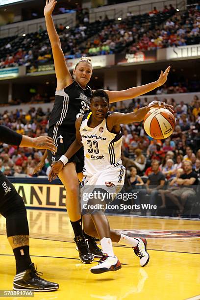 Indiana Fever forward Natasha Howard grabs the ball as she goes around San Antonio Stars center Jayne Appel during the game between the San Antonio...