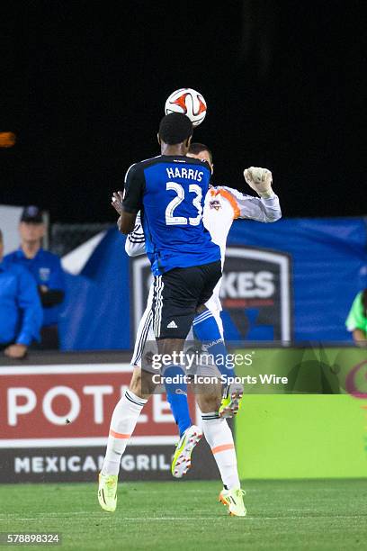 San Jose Earthquakes midfielder/forward Atiba Harris heads the ball past Houston Dynamo goalkeeper Tally Hall towards the goal, during the game...