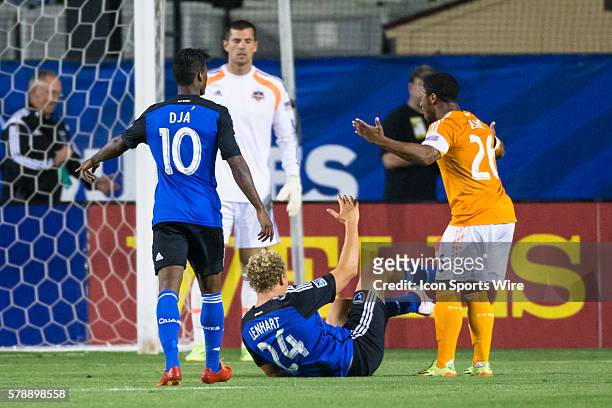 Houston Dynamo midfielder Corey Ashe argues against a penalty kick as San Jose Earthquakes forward Steven Lenhart lies on the ground with San Jose...
