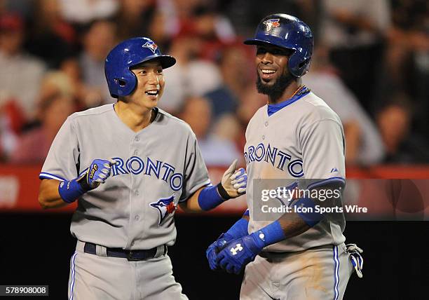 Toronto Blue Jays Munenori Kawasaki greets Jose Reyes after Reyes hit a two run home run in the seventh inning during a game against the Los Angeles...