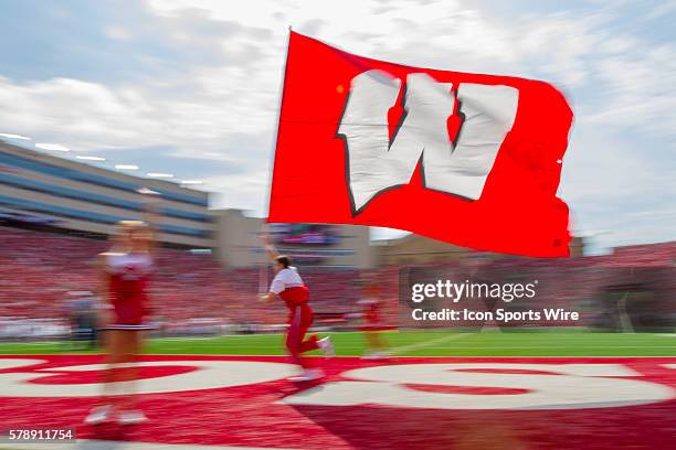 Wisconsin Badger cheerleader runs the flag across the end zone after scoring a touchdown as the Wisconsin Badgers defeated the Bowling Green Falcons...